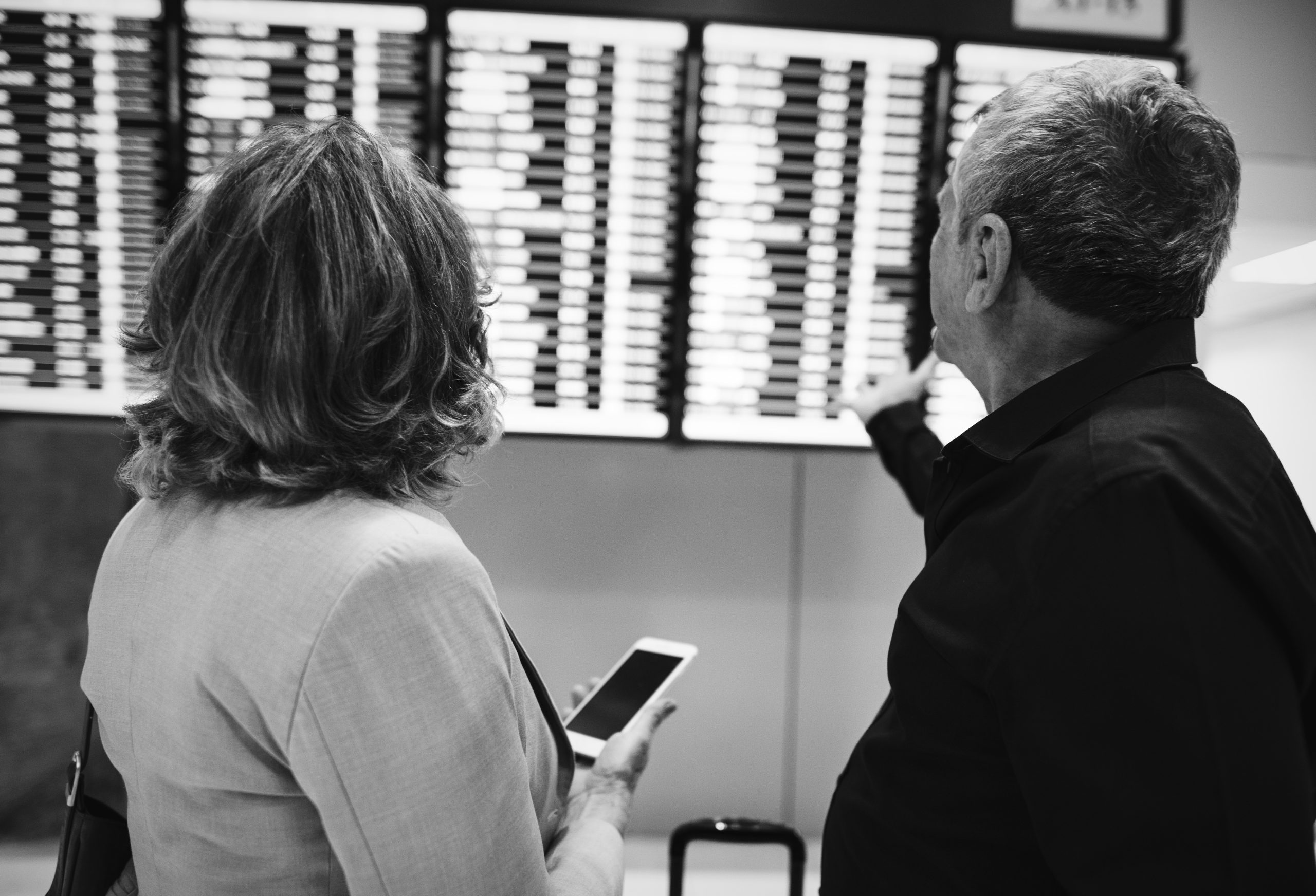 Caucasian couple is checking flight time schedule